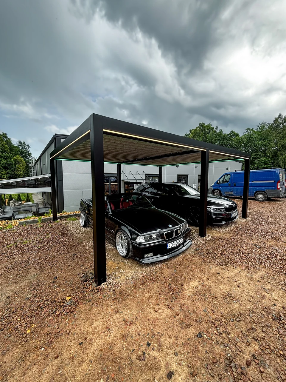 Carport z dwoma samochodami na placu