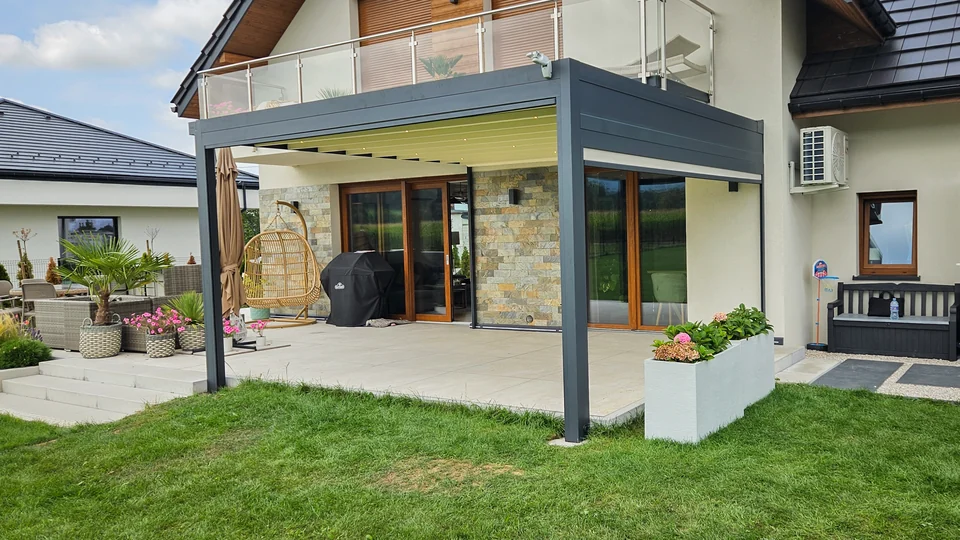 Pergola z jasnym dachem nad tarasem przy piętrowym domu